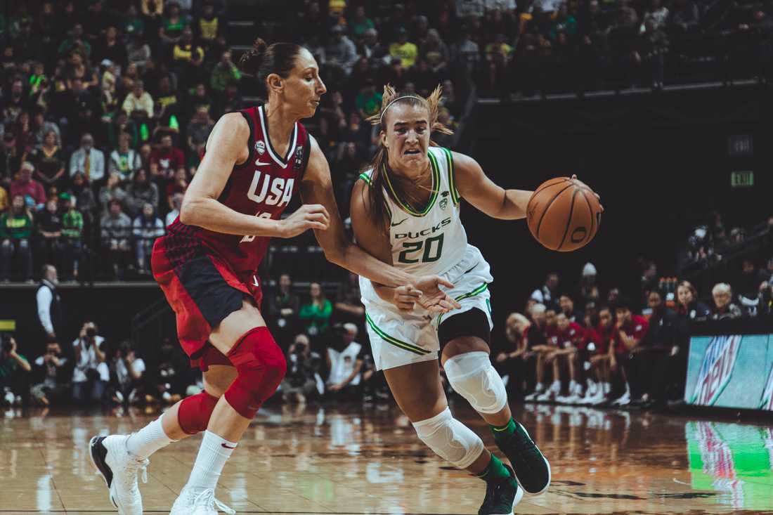 Ducks guard Sabrina Ionescu (20) muscles her way past USA defense. Oregon Ducks Women's Basketball kicks off the season by taking on the USA Women's National Team at Matthew Knight Arena in Eugene, Ore. on Nov. 9, 2019. (Sarah Northrop/Emerald)