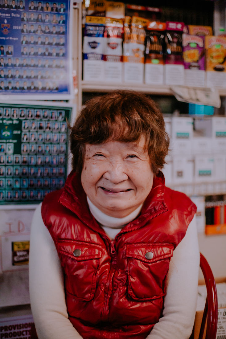 Ruth Yi sits behind the counter at Cottage Market, a local favorite convenience store on Hilyard Street that the student population calls "Ruth's." Born in South Korea, she attended university in Canada, opened a cafeteria in Los Angeles and worked at a dry cleaner's in Eugene before finally setting up shop at Cottage Market four years ago. (Sarah Northrop/Emerald)