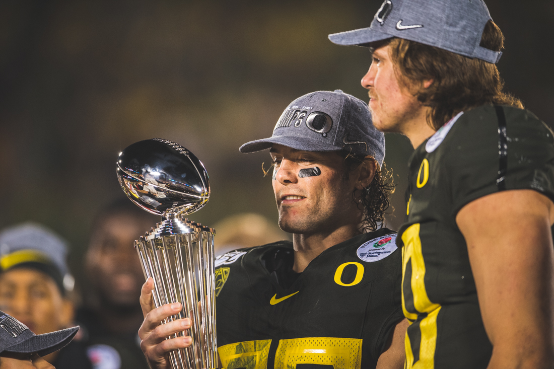 Ducks safety Brady Breeze (25) smiles in celebration as he holds the trophy. Oregon Ducks football takes on Wisconsin for the 106th Rose Bowl Game at Rose Bowl Stadium in Pasadena, Calif. on Jan. 1, 2020. (DL Young/Emerald)