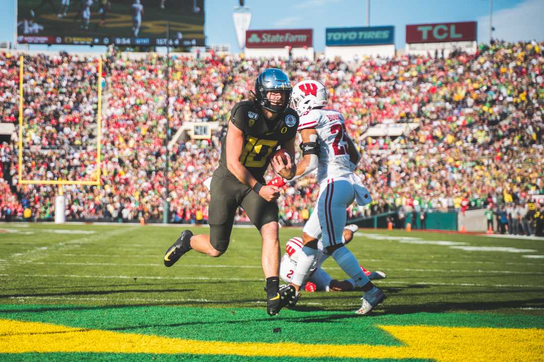 Ducks Justin Herbert (10) rushes for the first score of the game. Oregon Ducks football takes on Wisconsin for the 106th Rose Bowl Game at Rose Bowl Stadium in Pasadena, Calif. on Jan. 1, 2020. (DL Young/Emerald)