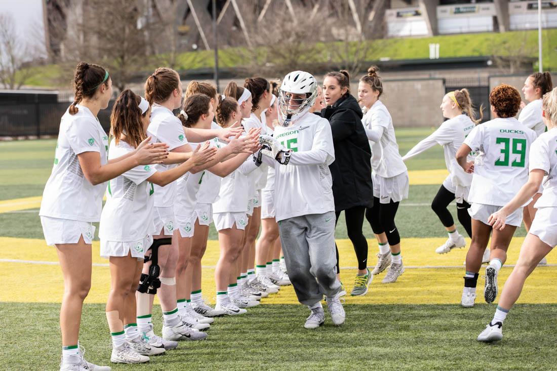 Goalkeeper, Alle Dunbar leads the team in their pre-game celebrations. Oregon Ducks Womens lacrosse bests the Liberty Flames, 20-12. (Madelyn Stellingwerf/Emerald)