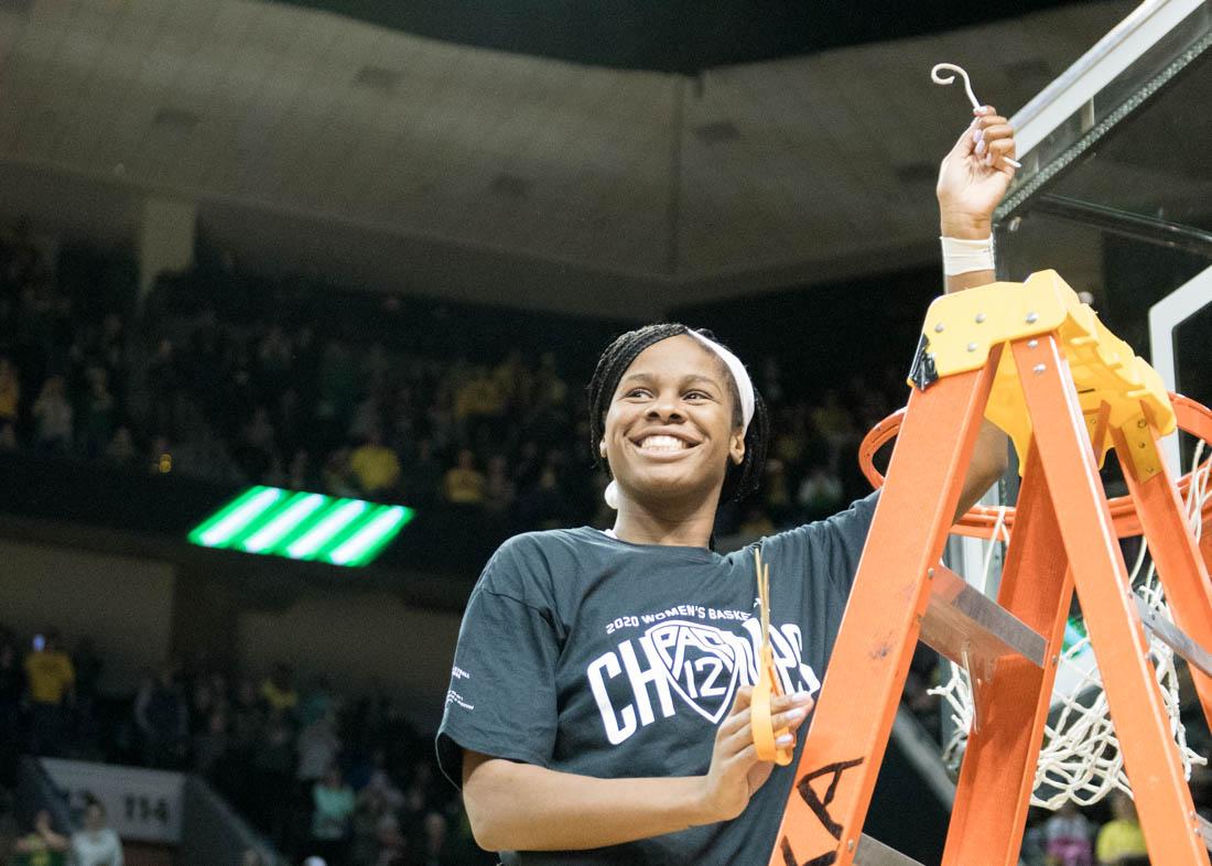 <p>Ruthy Hebard, forward for the Ducks, cuts off her piece of the net. Oregon Ducks women’s basketball takes on Washington State University at Matthew Knight Arena in Eugene, Ore. on Feb. 28, 2020. (Madi Mather/Emerald)</p>