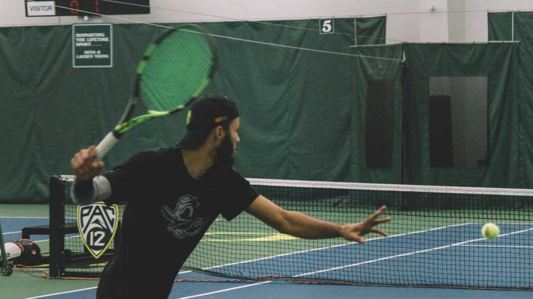 Ducks junior Ty Gentry winds up to hit the ball. Oregon Ducks men&#8217;s tennis takes on Boise State University at the Student Tennis Center in Eugene, Ore. on Feb. 08, 2019. (Connor Cox/Emerald)