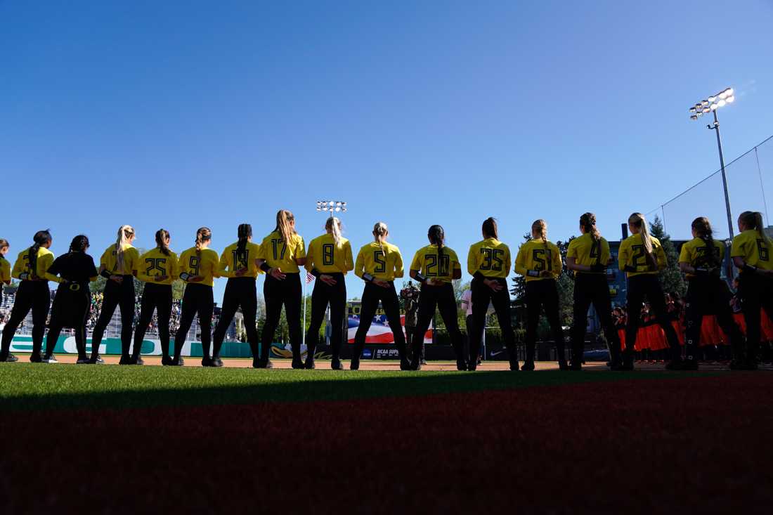 <p>The Ducks stand for the national anthem. Oregon Ducks softball takes on Oregon State University at Jane Sanders Stadium in Eugene, Ore. on April 26, 2019. (Ben Green/Emerald)</p>