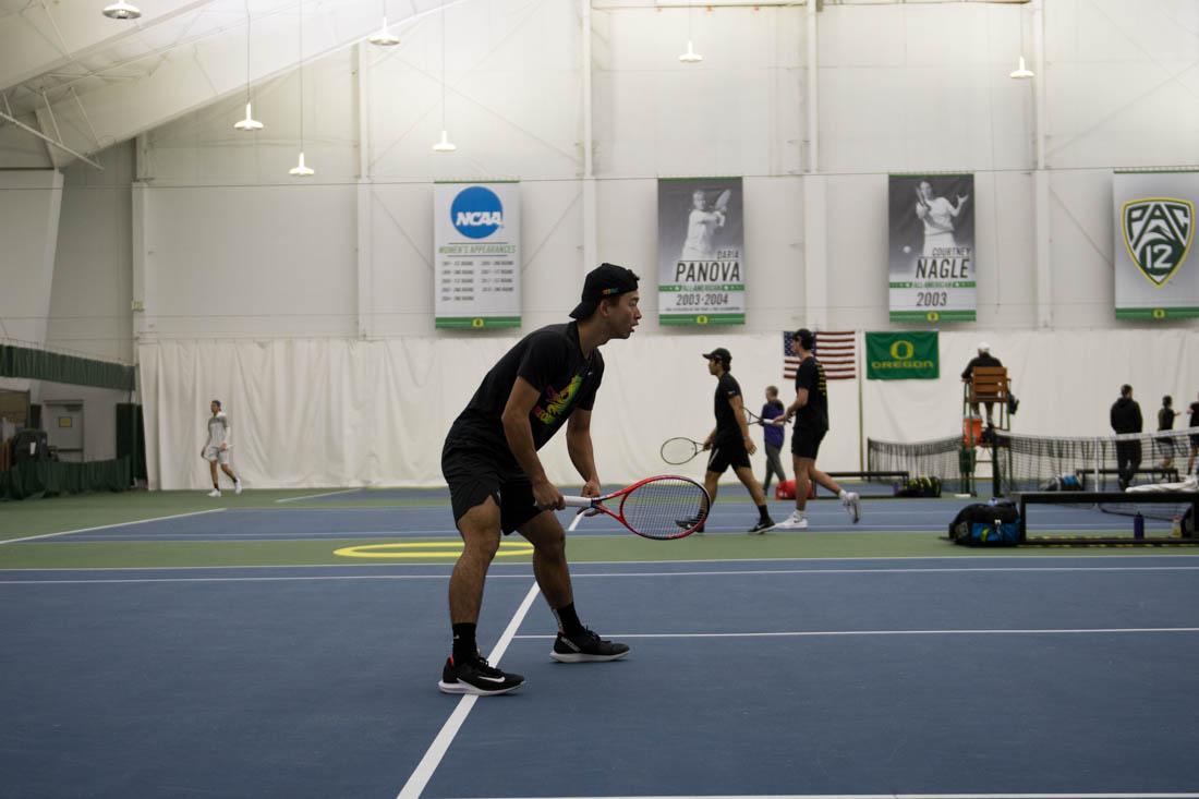 Riki Oshima, player for the Oregon Ducks, waits for a serve during a doubles game. The Oregon Ducks men&#8217;s tennis team played against the Washington Huskies in Eugene, Ore. on March 9, 2019. (Madi Mather/Emerald)