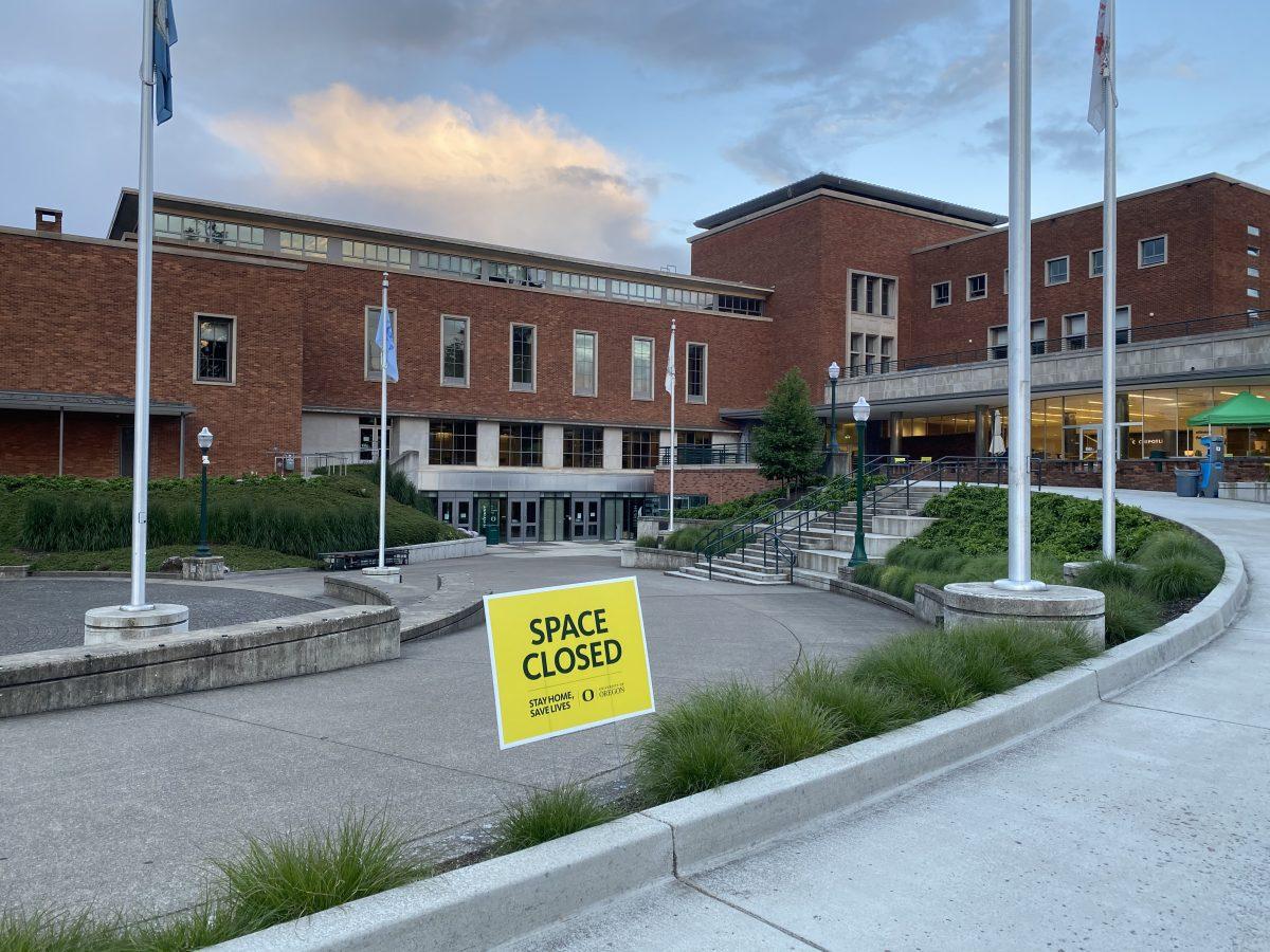 The empty amphitheater and it&#8217;s surrounding area at the Erb Memorial Union, with a sign indicating that the space is closed and saying &#8220;stay home, save lives.&#8221; The building is &#8220;operating &#8216;mostly remotely&#8217; with some limited services,&#8221; according to the&#160;EMU webpage.