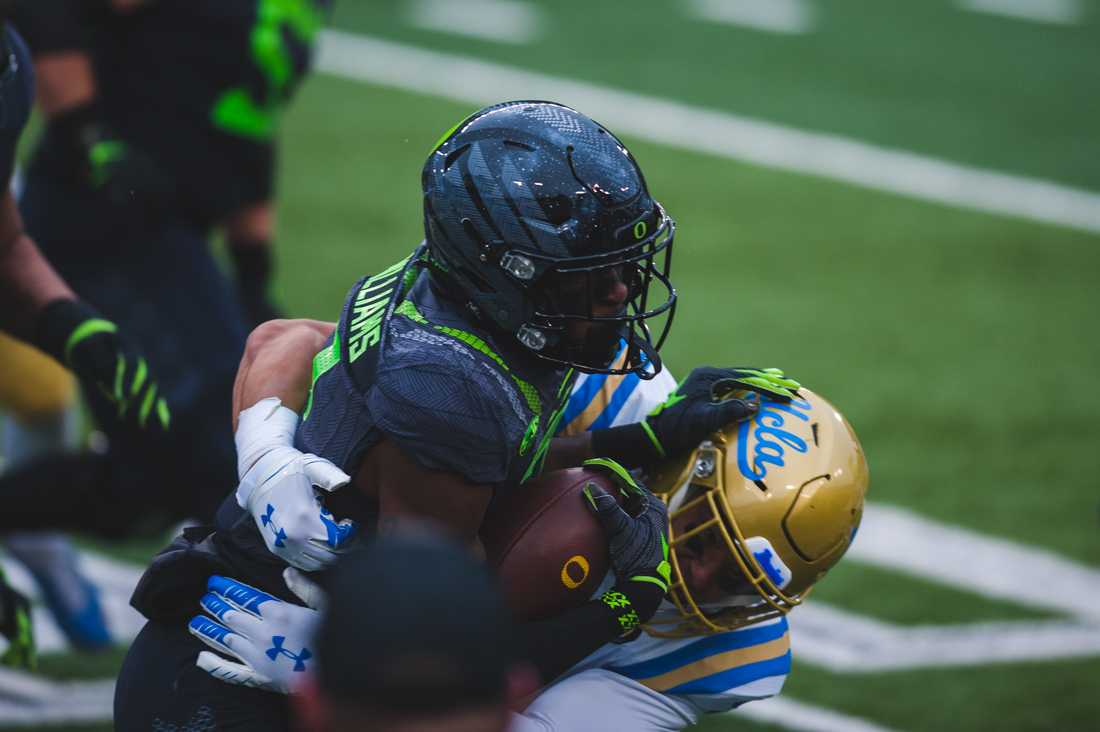 Ducks wide receiver Devon Williams (2) gets wrapped up by a bruin. Oregon Ducks football takes on the UCLA Bruins at Autzen Stadium in Eugene, Ore., on Nov. 21, 2020. (DL Young/Emerald)