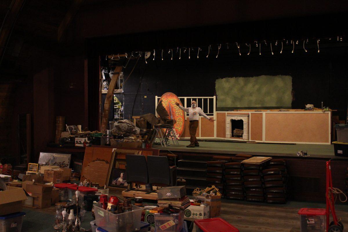 Very Little Theatre members and staff have volunteered to prep the theater for construction by removing props, equipment and old chairs to be organized and stored throughout the renovation. Chris Hansen, member of the VLT board, weaves through stacks of props and past the Little Women set before heading to stage right to check the progress of deconstruction by the scene shop. (Grace Murray Emerald)