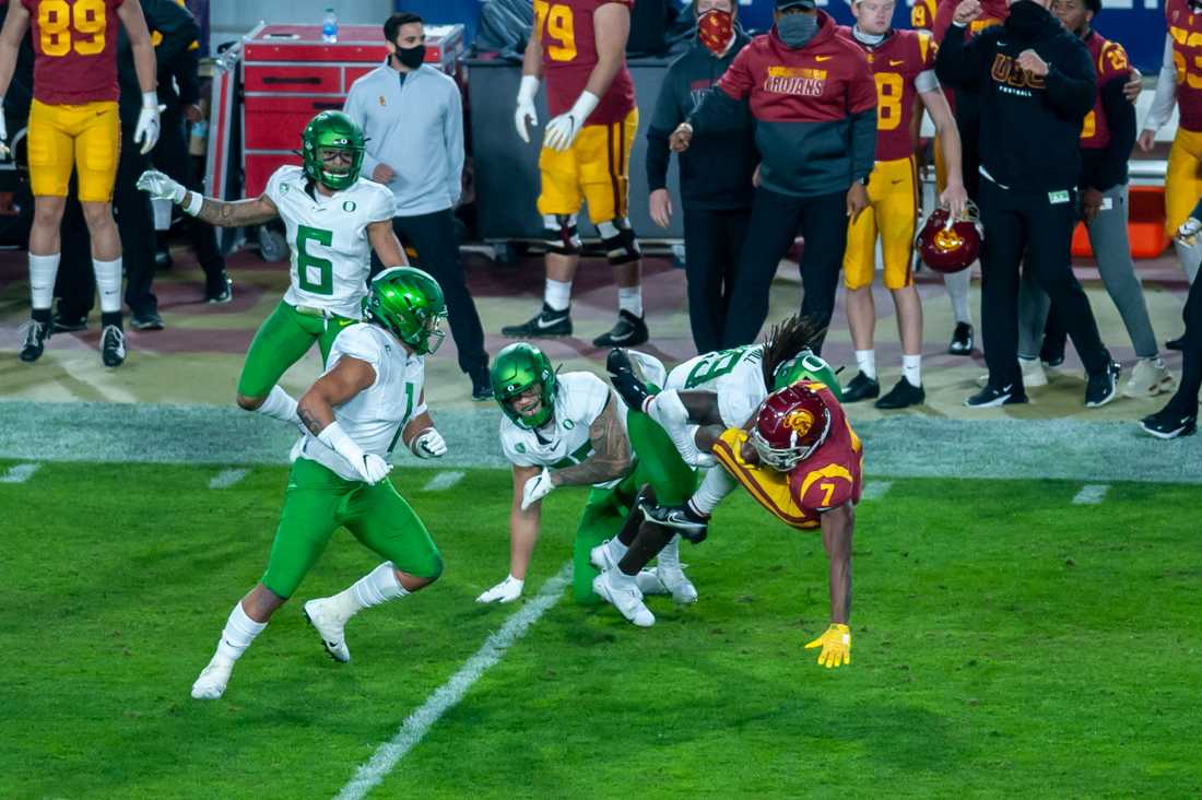 Ducks safety Jamal Hill (19) tackles a Trojan. Oregon Ducks football take on USC Trojans in the Pac-12 Championship game at Los Angeles Memorial Coliseum in Los Angeles, Calif., on Dec. 18, 2020. (Maddie Knight/Emerald)