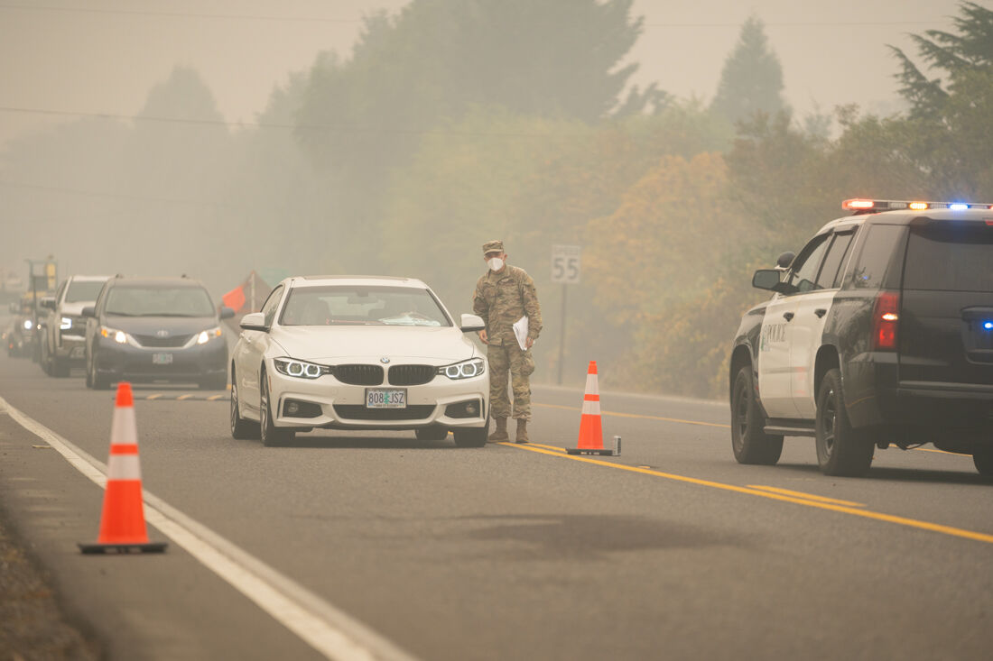 Along Highway 126 near Walterville, members of the National Guard are stationed along the highway to assist residents. The Holiday Farm Fire, one of the largest current wildfires in Oregon, began on Sept. 7, 2020 and has burned through multiple Oregon cities in over one week. The fire is still burning through Lane County, Ore. on Sep. 17, 2020. (Kevin Wang/Emerald)