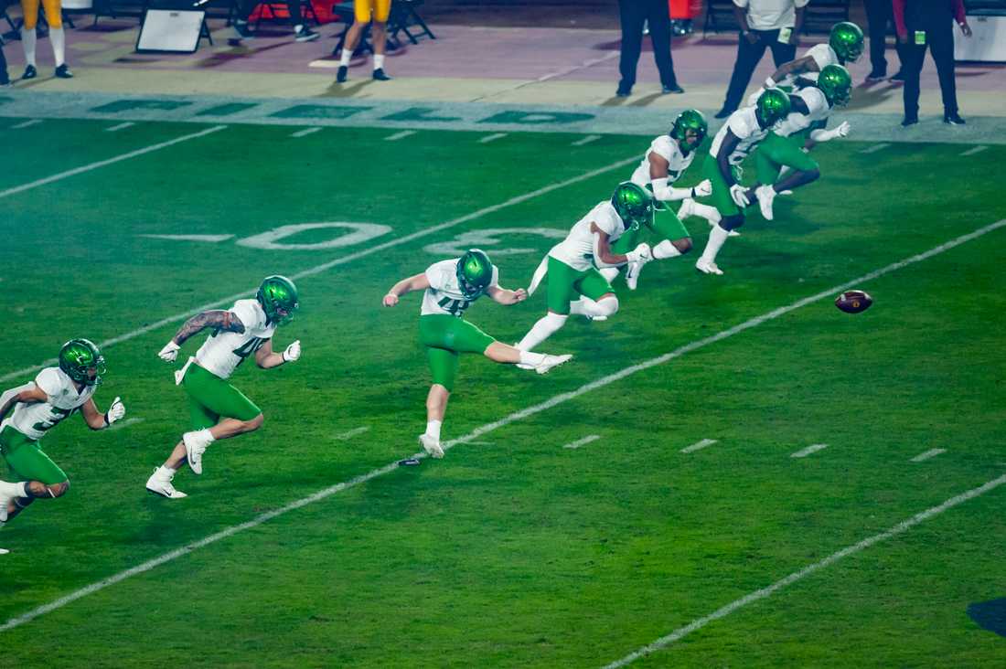 Oregon Ducks kicker Camden Lewis (49) kicks off the ball at the start of the game. Oregon Ducks football take on USC Trojans in the Pac-12 Championship game at Los Angeles Memorial Coliseum in Los Angeles, Calif., on Dec. 18, 2020. (Maddie Knight/Emerald)