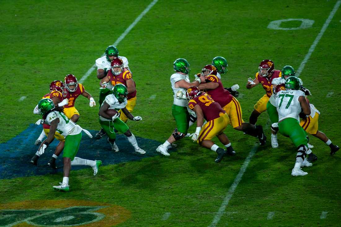 Ducks defensive end Kayvon Thibodeaux (5) dodges other players. Oregon Ducks football take on USC Trojans in the Pac-12 Championship game at Los Angeles Memorial Coliseum in Los Angeles, Calif., on Dec. 18, 2020. (Maddie Knight/Emerald)