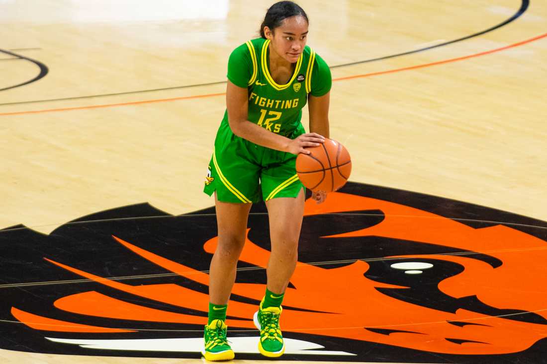 Ducks guard Te-Hina PaoPao (12) brings the ball into play. Oregon Ducks take on the Oregon State Beavers at Gill Coliseum in Corvallis, Ore., on Dec. 13, 2020. (Kimberly Harris/Emerald)