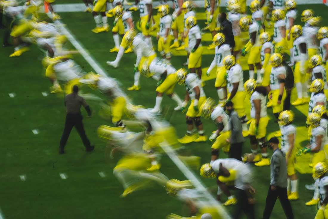 The Oregon Ducks run during warmups. Oregon Ducks football takes on Iowa State for the Fiesta Bowl at State Farm Stadium in Glendale, Ariz., on Jan. 2, 2021. (DL Young/Emerald)