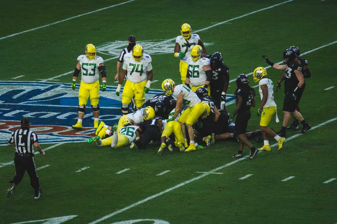 Both teams pile up to grab a loose ball. Oregon Ducks football takes on Iowa State for the Fiesta Bowl at State Farm Stadium in Glendale, Ariz., on Jan. 2, 2021. (DL Young/Emerald)