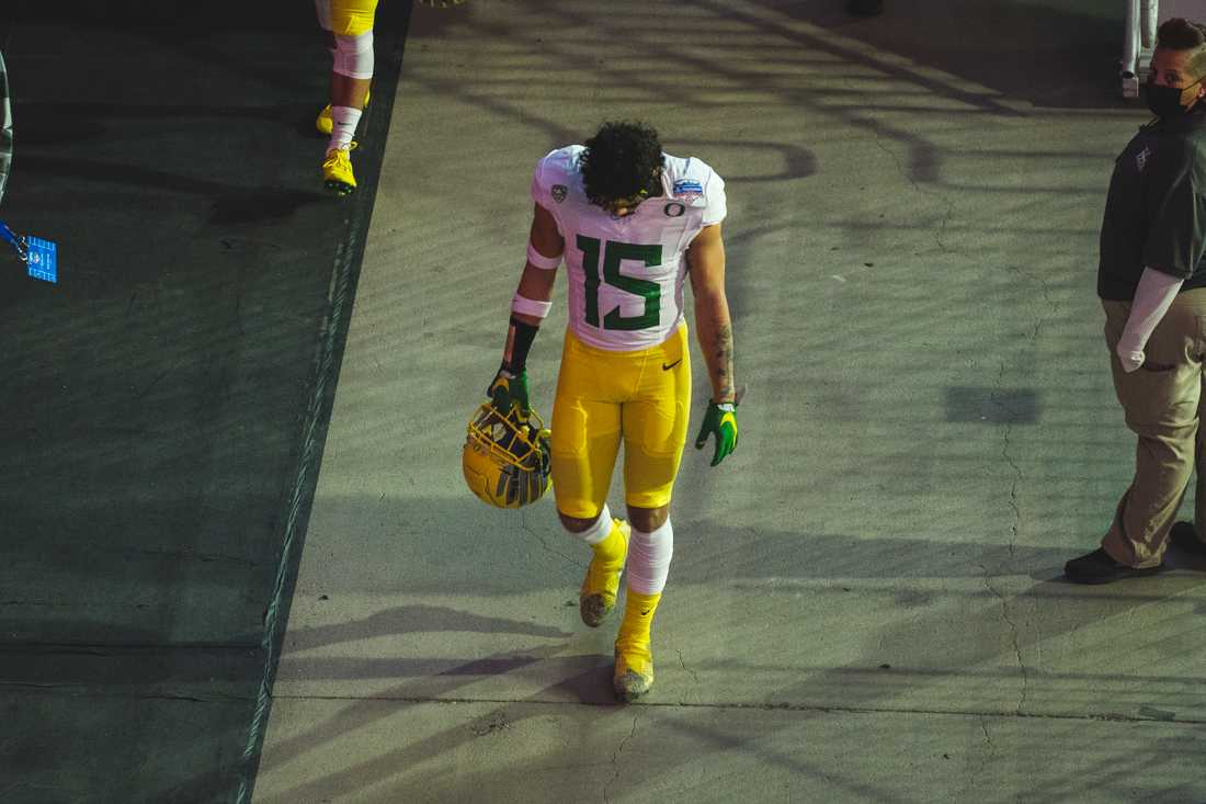 Ducks safety Bennett Williams (15) hangs his head during his walk back to the locker room. Oregon Ducks football takes on Iowa State for the Fiesta Bowl at State Farm Stadium in Glendale, Ariz., on Jan. 2, 2021. (DL Young/Emerald)