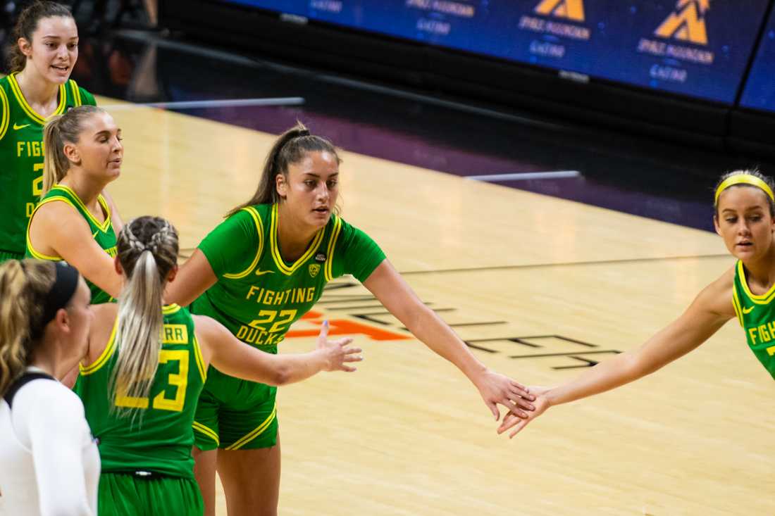 Ducks forward Kylee Watson (22) receives support from her teammates after completing a foul shot. Oregon Ducks take on the Oregon State Beavers at Gill Coliseum in Corvallis, Ore., on Dec. 13, 2020. (Kimberly Harris/Emerald)