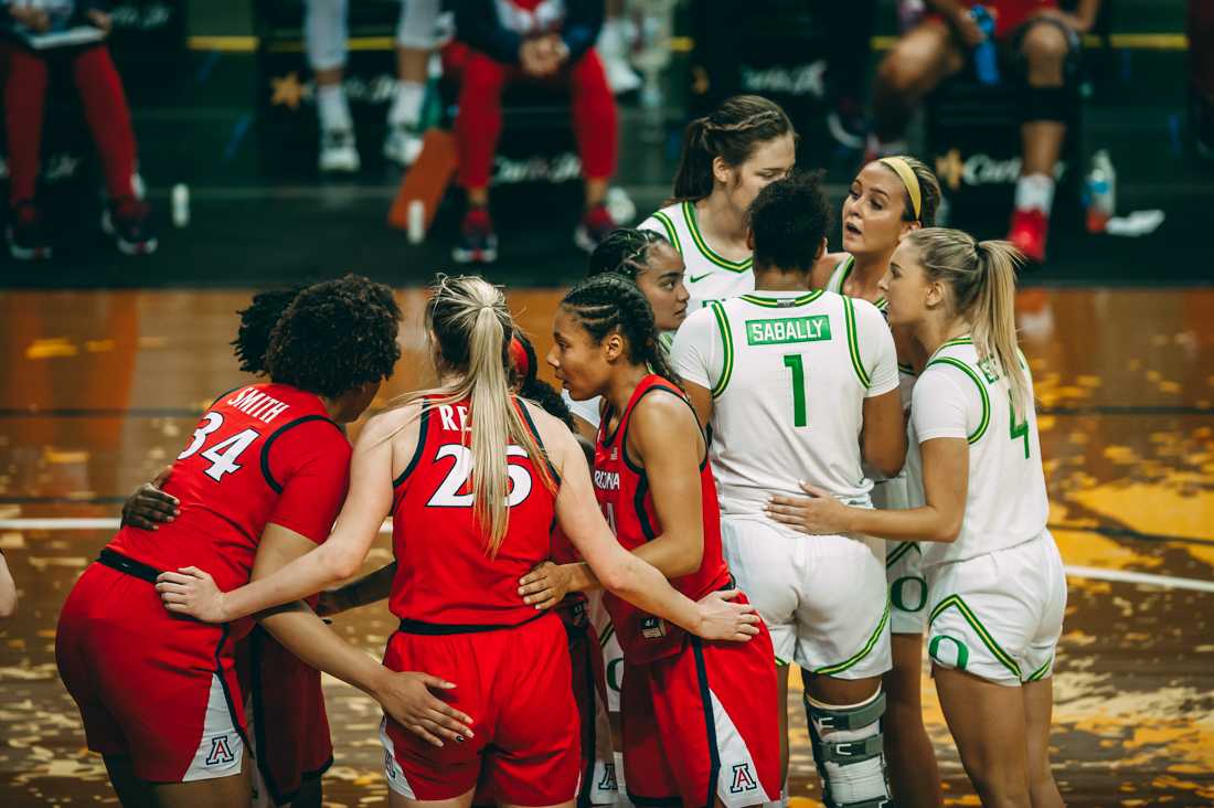 Both teams huddle together before time resumes during he game. Ducks women's basketball takes on University of Arizona at Matthew Knight Arena in Eugene, Ore., on Feb. 8, 2021. (DL Young/Emerald)