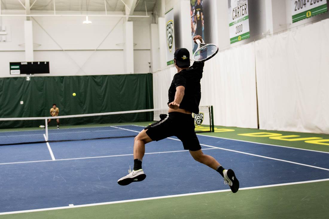 Ducks player Ryoma Matsushita jumps and deflects the ball. Oregon Ducks men&#8217;s tennis takes on the Cal Poly Mustangs at the Oregon Student Tennis Center in Eugene, Ore., on March 7, 2021. (Ian Enger/Emerald)