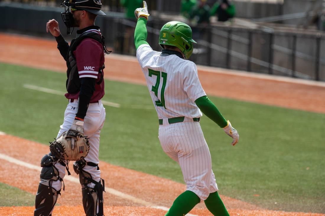 <p>Ducks outfielder Tanner Smith (31) celebrates as he runs across home base, scoring for Oregon. Oregon Ducks baseball take on the New Mexico State Aggies at PK Park in Eugene, Ore., on April 3, 2021. (Maddie Stellingwerf/Emerald)</p>