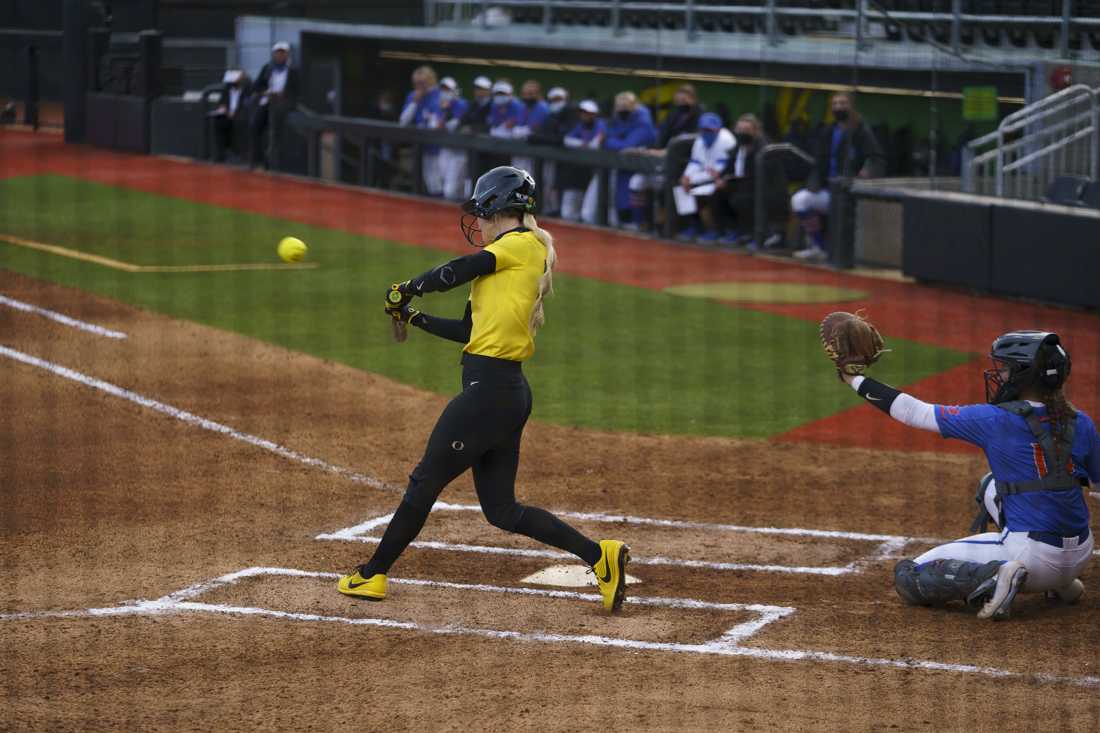 Ducks outfielder Haley Cruse (26) hits the first home-run in the first inning. Oregon softball takes on Boise State University at Jane Sanders Stadium in Eugene, Ore. on March 06, 2021. (Kevin Wang/Daily Emerald)