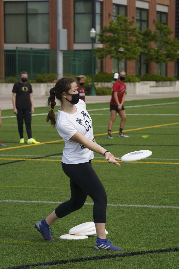 A player throws a frisbee during drills. Oregon&#8217;s women ultimate frisbee team, also known as Fugue, held practice on May 9th, 2021 at the Rec Fields at the University of Oregon campus. This gave an opportunity for students to try out for the team. (Kevin Wang/Daily Emerald)