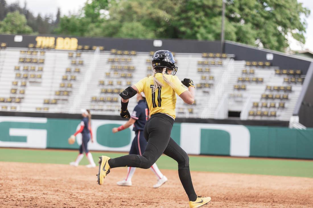 Ducks catcher Terra McGowan (11) begins her journey to home after hitting a home run in the last inning. Oregon Ducks take on Arizona Wildcats at Jane Sanders Stadium in Eugene, Ore., on May 7, 2021 (Maddie Stellingwerf/Emerald)