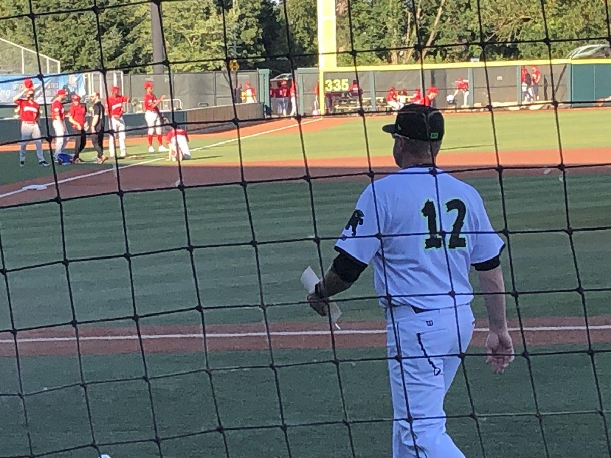 Eugene Emeralds manager Dennis Pelfrey walks to home plate for a pregame meeting with the umpires and Vancouver Canadians' manager.