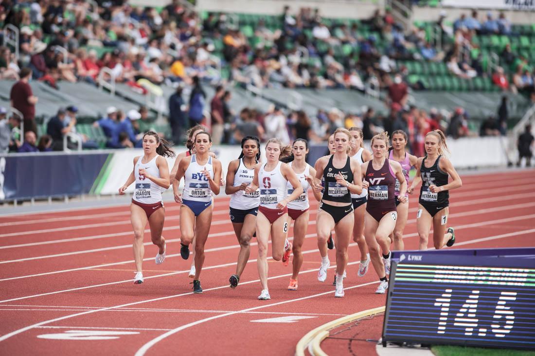 Women competing in the steeplchase event round the corner of their first lap. Hayward Field hosts the second day of the 2021 NCAA Outdoor Track and Field Championships in Eugene, Ore., on June 10, 2021 (Maddie Stellingwerf/Emerald).