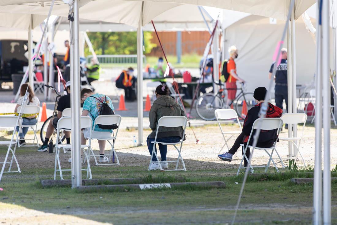 <p>Walk-up patients sit socially distanced and await their first shot. University of Oregon begins to distribute Vaccines to Students and Faculty on April 21, 2021. (Maddie Stellingwerf/Emerald)</p>