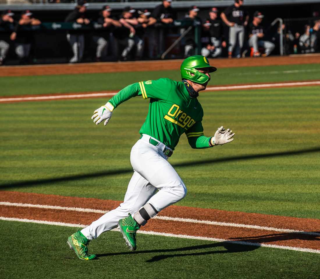 Oregon Ducks outfielder Aaron Zavala (13) heads to first base after hitting the ball. Oregon Ducks baseball takes on the Oregon State Beavers at PK Park in Eugene, Ore., on April 11, 2021. (Ian Enger/Emerald)