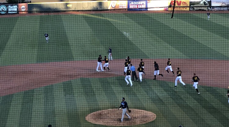 The Eugene Emeralds run out to mob Sean Roby at second base after his walk-off double in the bottom of the ninth to secure a 6-5 win over the Hillsboro Hops.