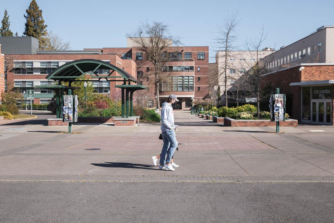 Students once again cross the intersection beside Allen Hall. After a year of adapting to the COVID-19 pandemic, students are back to spending time on the University of Oregon campus and enjoying the spring weather. (Maddie Stellingwerf/Emerald)