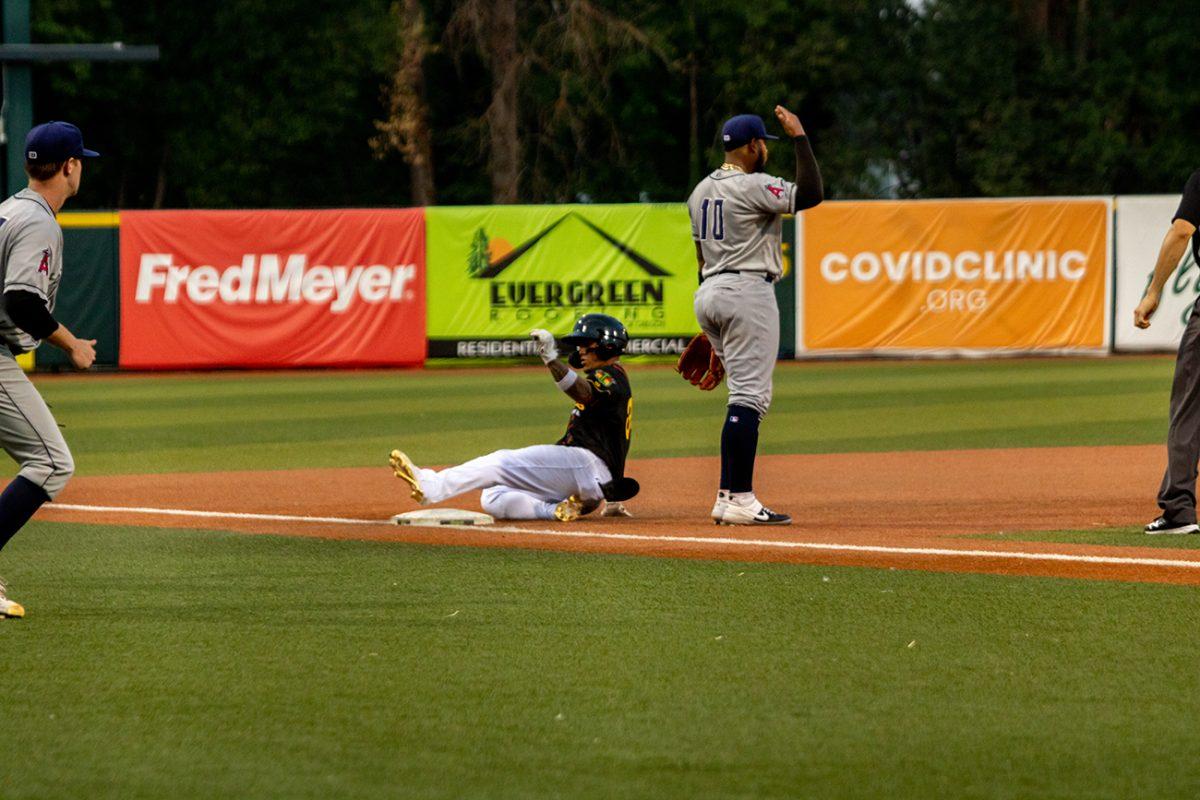 Ismael Munguia (38) slides into third base. The Eugene Emeralds, who played under their alternate name Monarcas de Eugene, defeated the Tri-City Dust Devils 11-4 on Tuesday, August 3, at PK Park in Eugene, Oregon. (Will Geschke/Emerald)