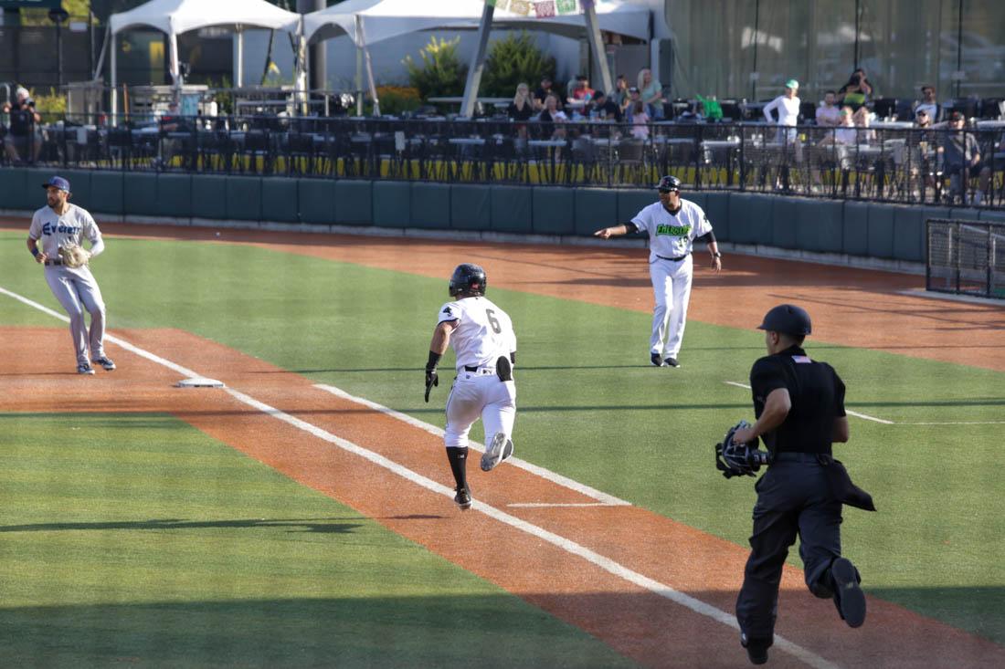 <p>Brett Auerbach (6) makes a run for first base. (Ali Watson/Emerald)</p>