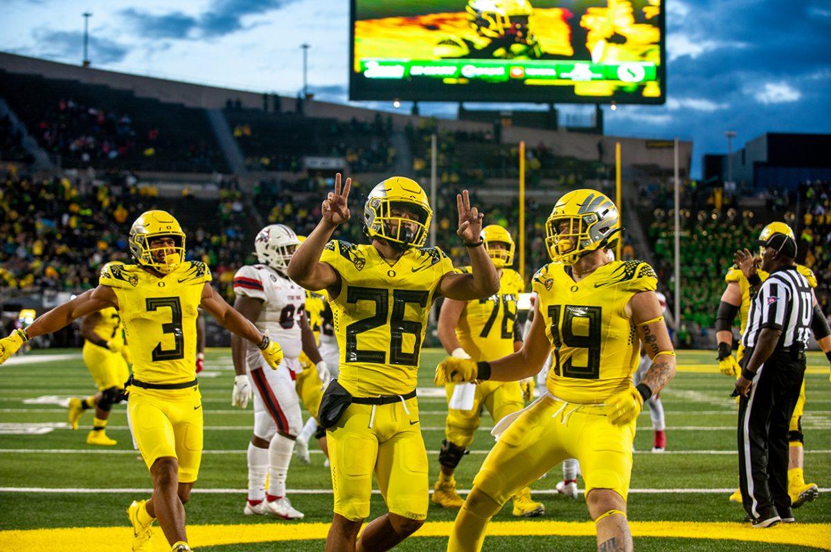 Travis Dye gestures towards the crowd while celebrating scoring a touchdown for Oregon. The Oregon Ducks defeated the Stony Brook Seawolves 48-7 on Saturday night, September 17, at Autzen Stadium. (Will Geschke/Emerald)