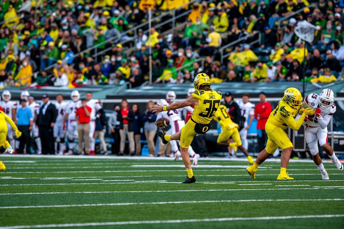 Tom Snee (38) punts a ball. The Oregon Ducks defeated the Stony Brook Seawolves 48-7 on Saturday night, September 17, at Autzen Stadium. (Will Geschke/Emerald)