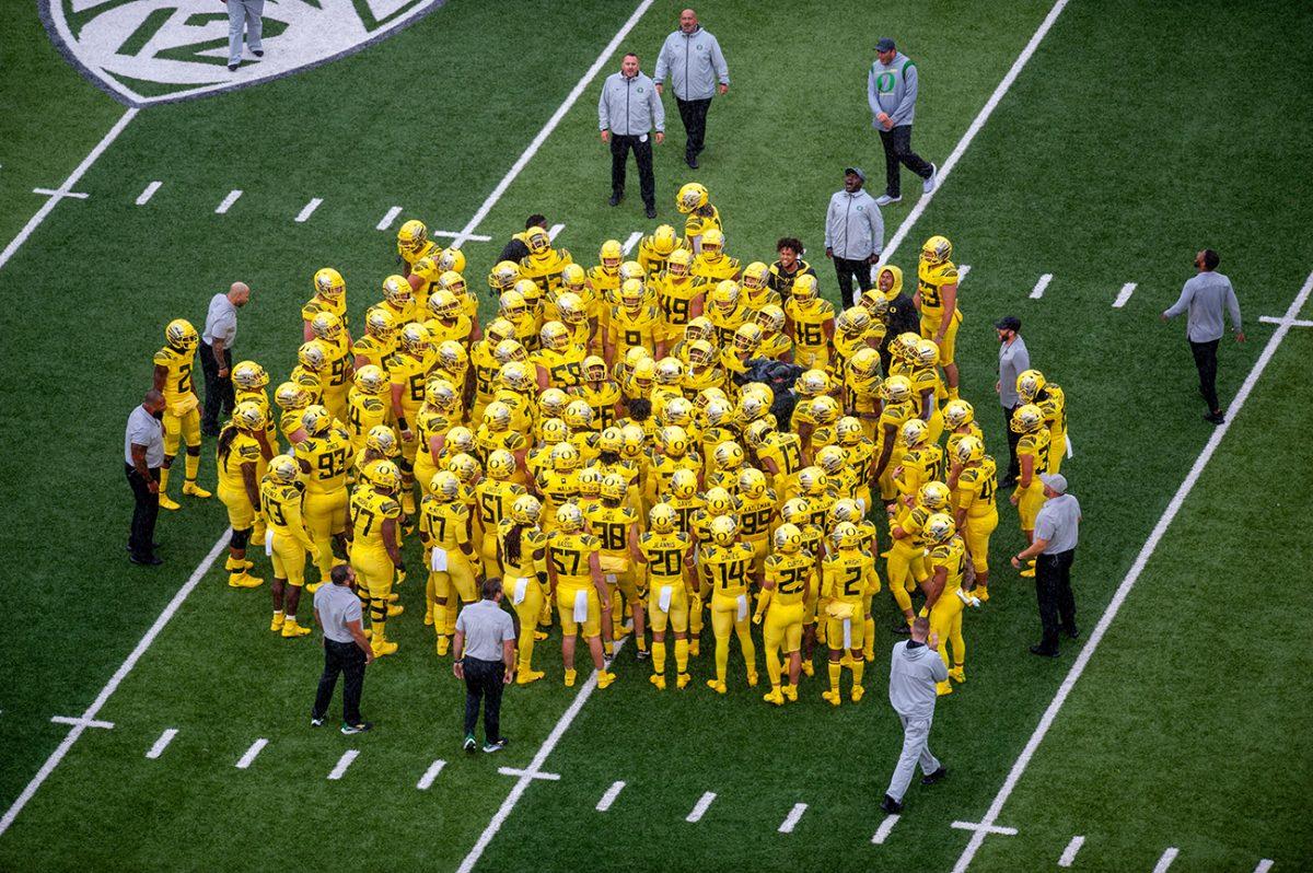 Oregon Ducks players gather on the field before the beginning of the game was delayed by thunderstorms. The Oregon Ducks defeated the Stony Brook Seawolves 48-7 on Saturday night, September 17, at Autzen Stadium. (Will Geschke/Emerald)