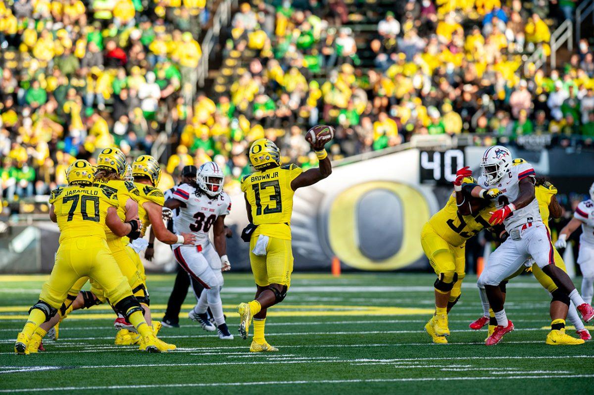 Anthony Brown (13) throws a pass to an Oregon teammate. The Oregon Ducks defeated the Stony Brook Seawolves 48-7 on Saturday night, September 17, at Autzen Stadium. (Will Geschke/Emerald)