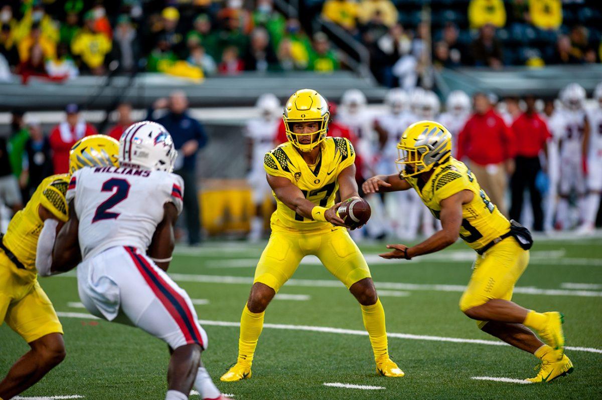 Ty Thompson (17) looks towards a Stony Brook defender as he hands off the ball. The Oregon Ducks defeated the Stony Brook Seawolves 48-7 on Saturday night, September 17, at Autzen Stadium. (Will Geschke/Emerald)