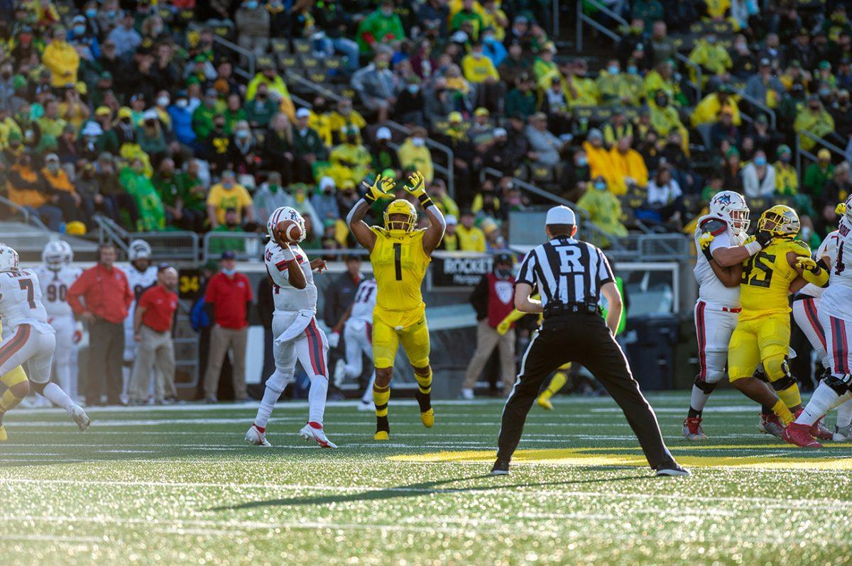 Noah Sewell (1) attempts to block a pass coming from Stony Brook quarterback Tyquell Fields (4). The Oregon Ducks defeated the Stony Brook Seawolves 48-7 on Saturday night, September 17, at Autzen Stadium. (Will Geschke/Emerald)