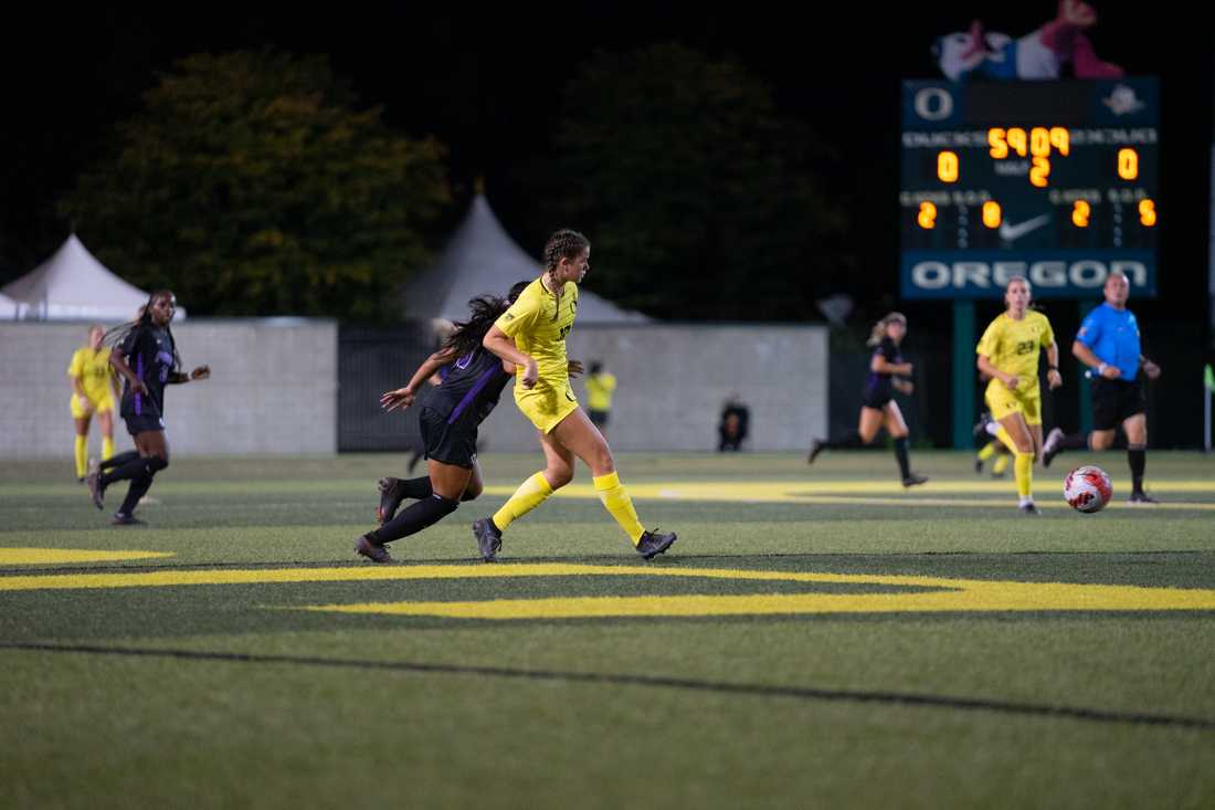 <p>Ducks Defender Anna Phillips passes the ball away from a Portland Forward player. Oregon Ducks Soccer take on the University of Portland Pilots at Papé Field in Eugene, Ore., on September 17, 2021. (Serei Hendrie/Emerald)</p>