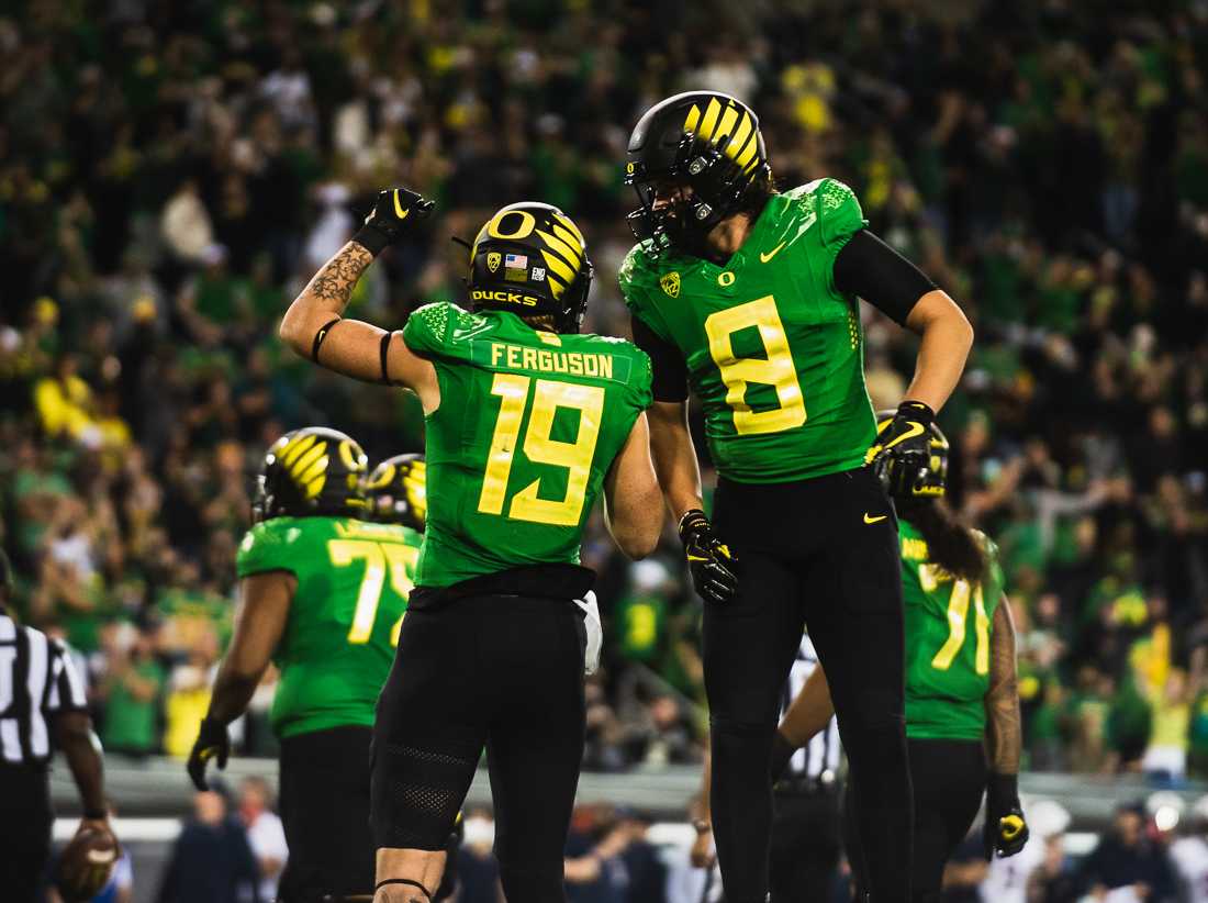 Ducks tight ends Terrance Ferguson (19) and Moliki Matavao (8) celebrate after Ferguson scored on Arizona, giving the Ducks a 24-7 lead. The Oregon Ducks crush the Arizona Wildcats 41-19 in game four of the 2021 season. (Ian Enger/ Emerald)