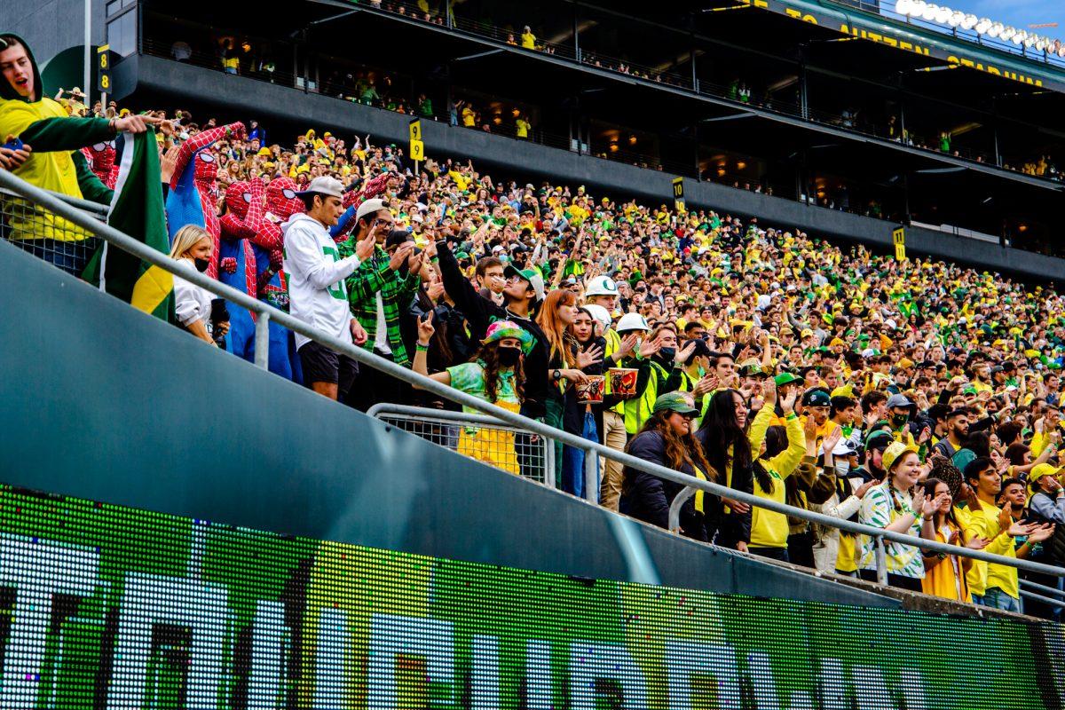 Ducks fans in the student section celebrate the touchdown. The University of Oregon Ducks defeated the University of Colorado Buffaloes 52-29 at Autzen Stadium on October 30, 2021. (Will Geschke/Emerald)