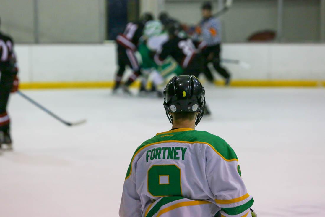 Kirt Fortney (9) watches from the defensive line as his teammates fight for control of the puck against the boards. Oregon Ducks play San Diego State Aztecs on a cold October night. (Ali Watson/Emerald)