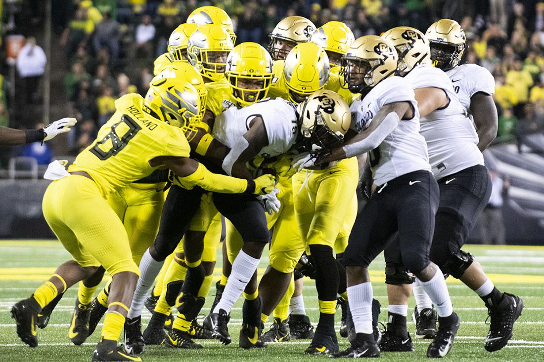 The Ducks swarm to the ball. Oregon Ducks Football takes on the Colorado Buffaloes at Autzen Stadium in Eugene, Ore. on Oct. 11, 2019. (Kimberly Harris/Emerald)