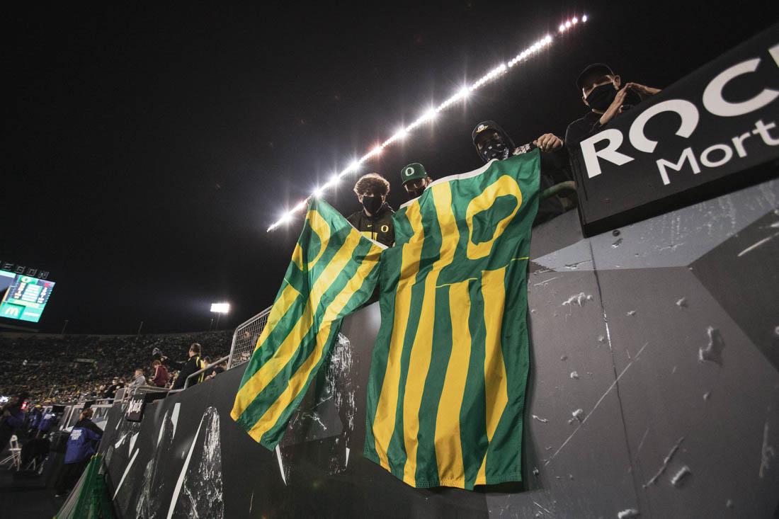 Fans wave their Ducks flags after a successful touchdown by Ducks offense. Ducks football take on the Washington State Cougars at Autzen Stadium in Eugene, Ore., on Nov. 13, 2021. (Maddie Stellingwerf)