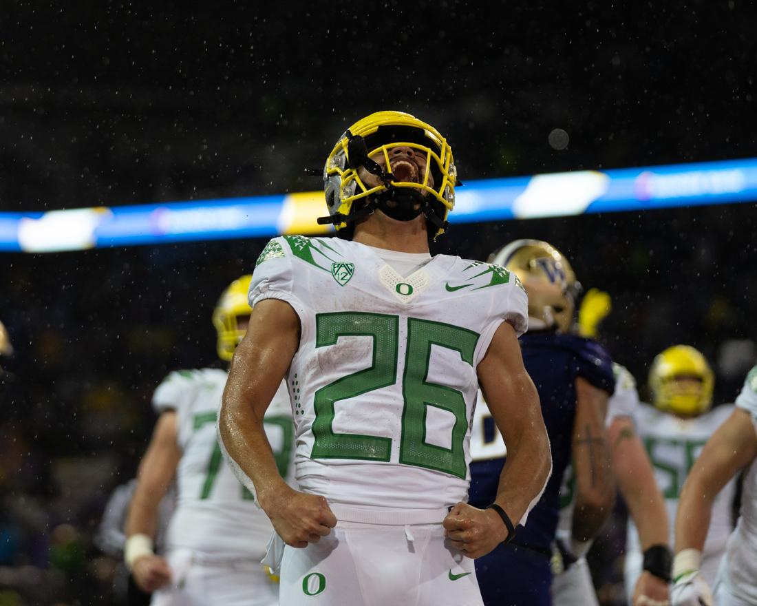 Troy Dye (26) celebrates after runing the ball in for a touchdown. The Oregon Ducks take on the Washington Huskies at Husky Stadium in Seattle, Wash., on November 6, 2021. (Serei Hendrie/Emerald)