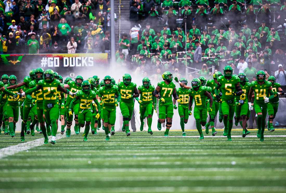 The Oregon Ducks run onto the field for the 124th Ducks vs Beavers football game. The University of Oregon Ducks hosted and defeated the Oregon State Beavers 38-29, claiming the Pac-12 North champions title. (Emerald/ Ian Enger)