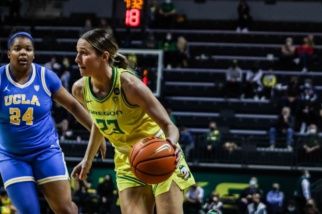 Maddie Scherr (32) takes the ball around her defender towards the key. Oregon Women&#8217;s Basketball takes on UCLA Bruins at Matthew Knight Arena in Eugene, Ore. on Feb. 16, 2022. (Mary Grosswendt/Emerald)